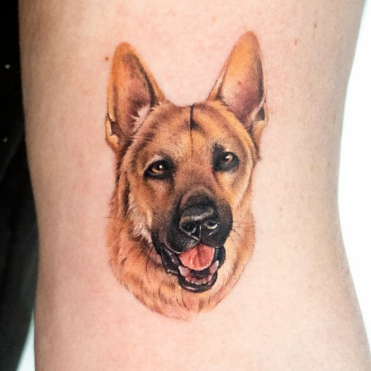 Colour tattoo of Dias's face on an upper arm